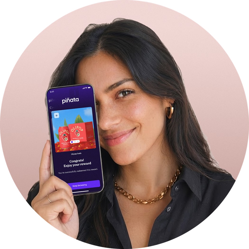 girl holding up iPhone running Piñata app